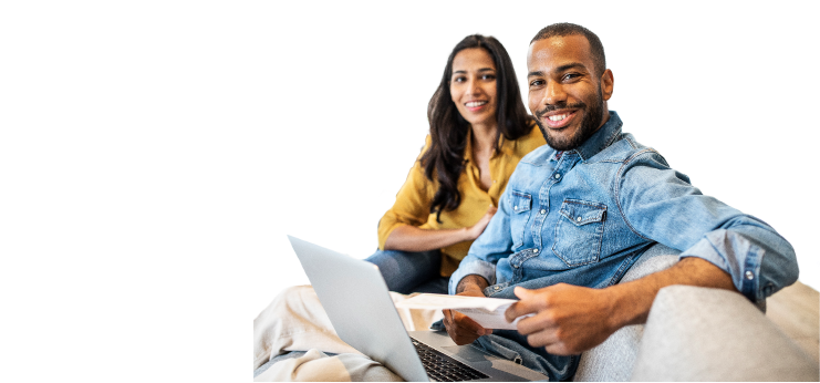 NPX homeowners sitting on a couch with a laptop